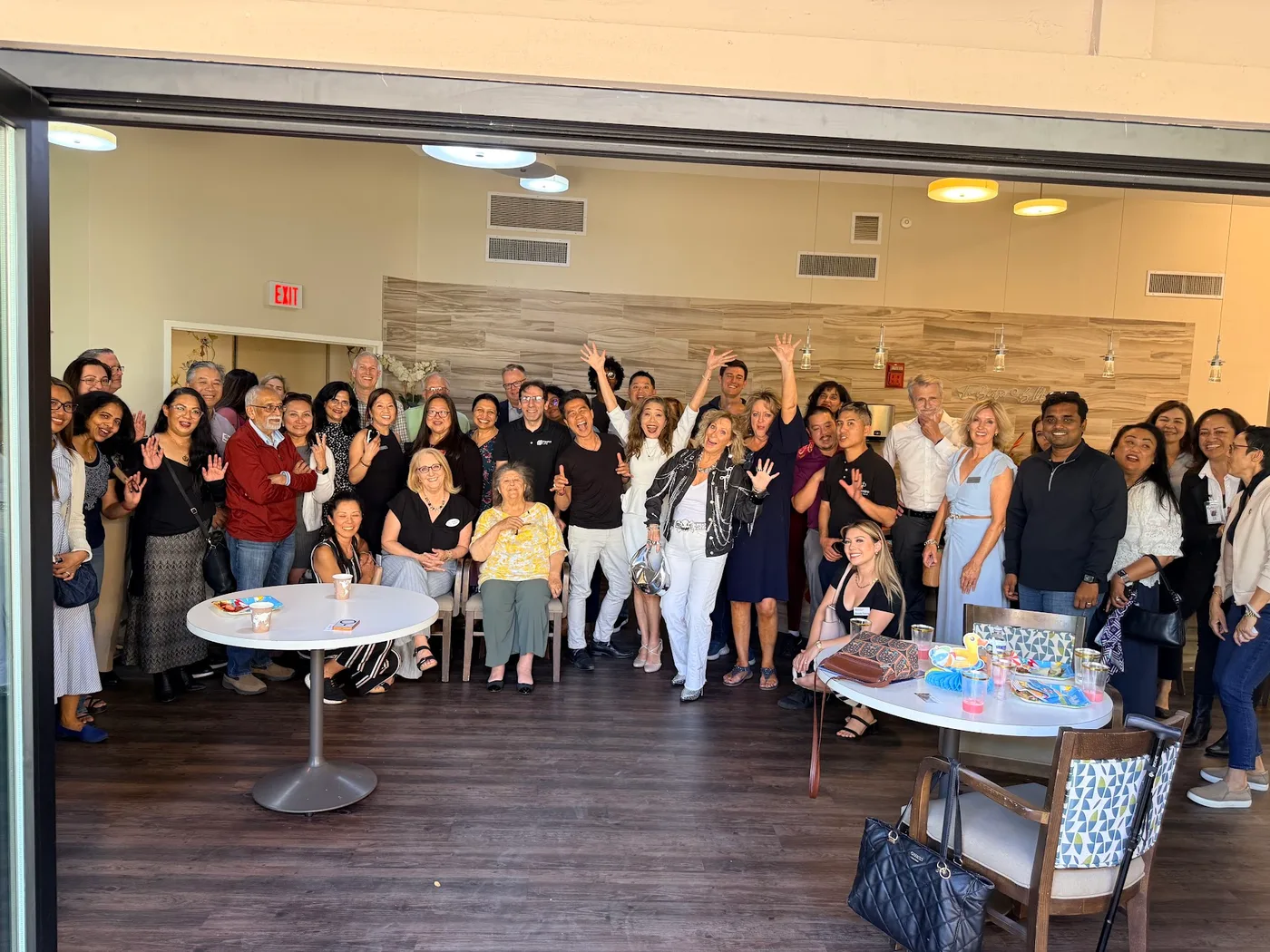 A full room of guests cheering at a Mixer